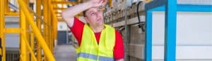 Warehouse Worker Wiping Sweat: keep warehouse cool in summer